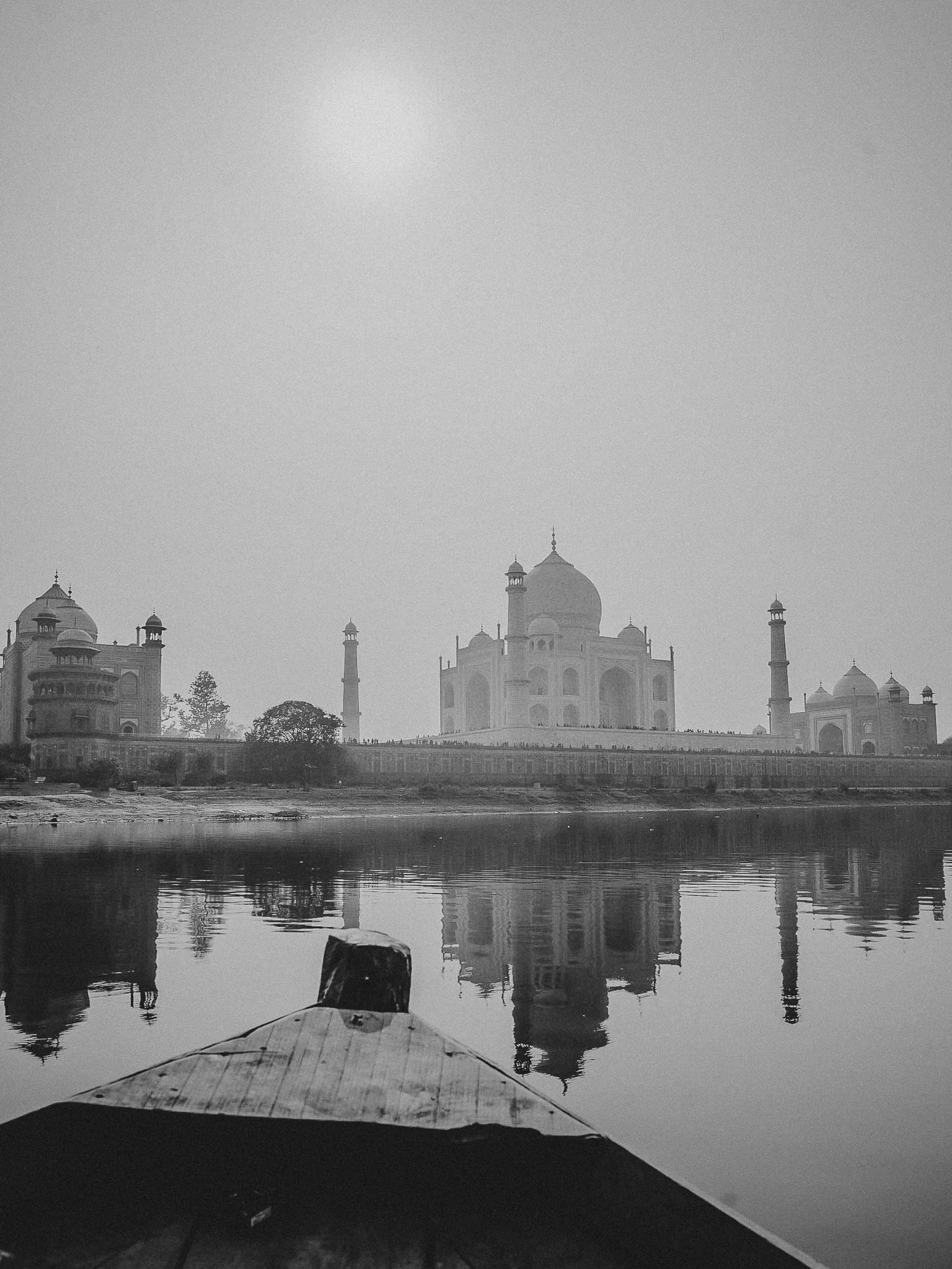 The Taj Mahal viewed from the riverside in Agra, India, photographed at sunrise from the opposite bank of the Yamuna River.