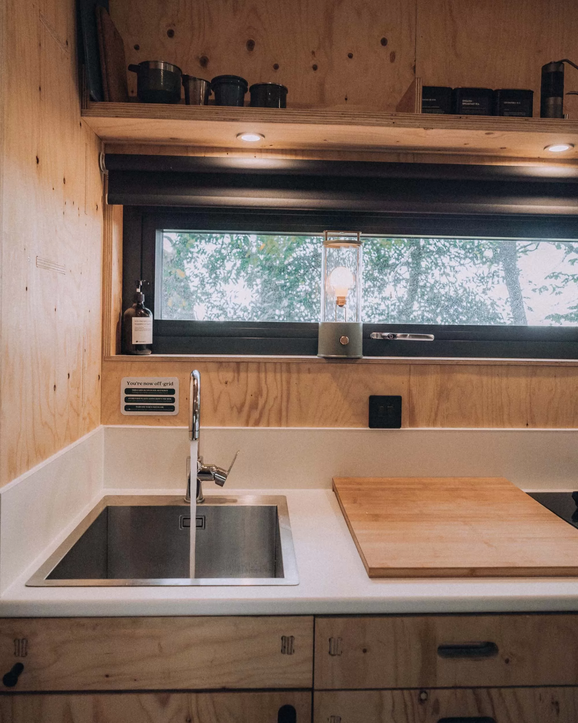 A wooden clad kitchen in a cabin