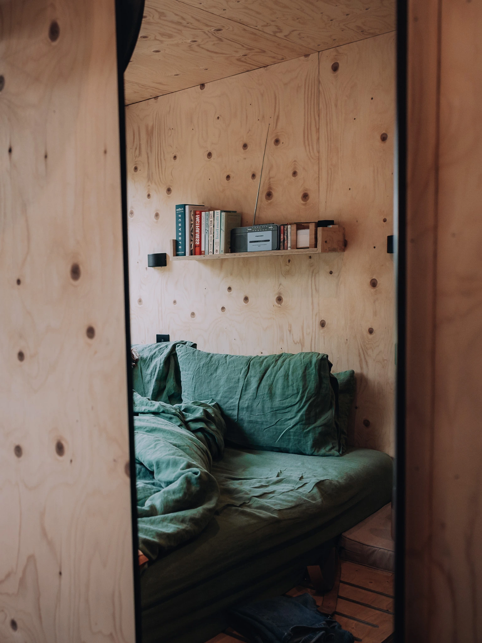 Cosy bedroom inside the Unplugged Mabel cabin in East Sussex