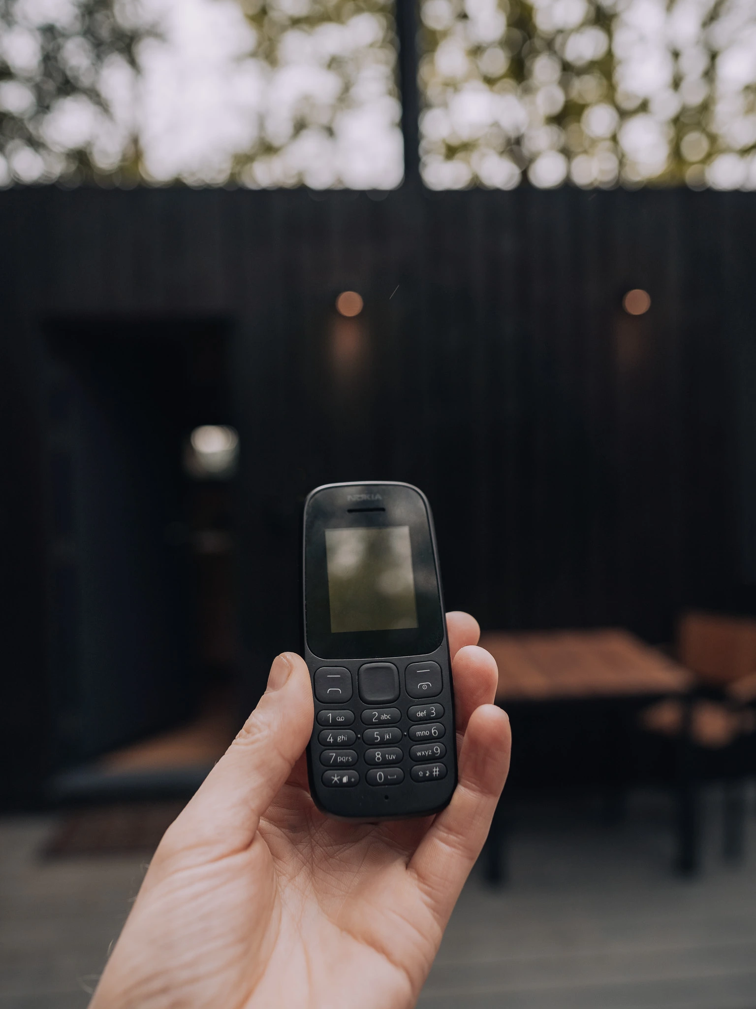 Holding an old Nokia emergency phone outside the Unplugged Mabel cabin in East Sussex