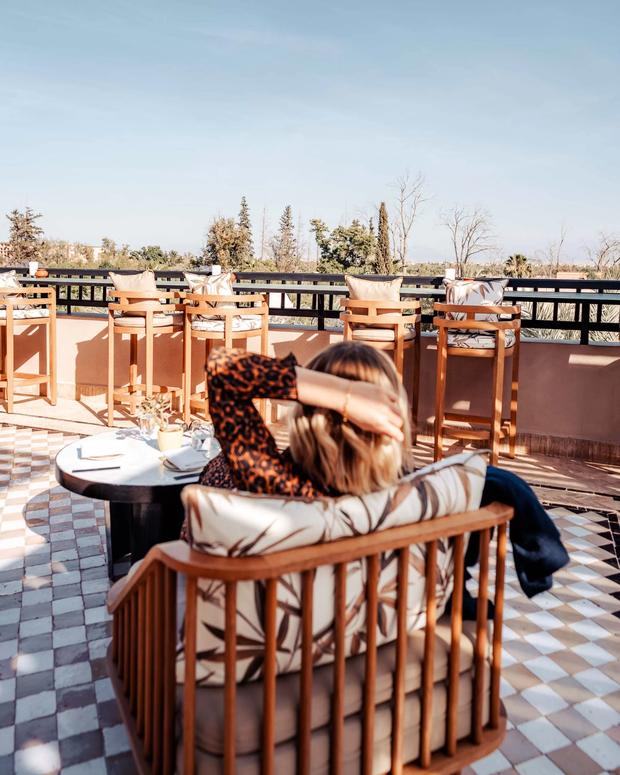 Woman relaxing at rooftop bar