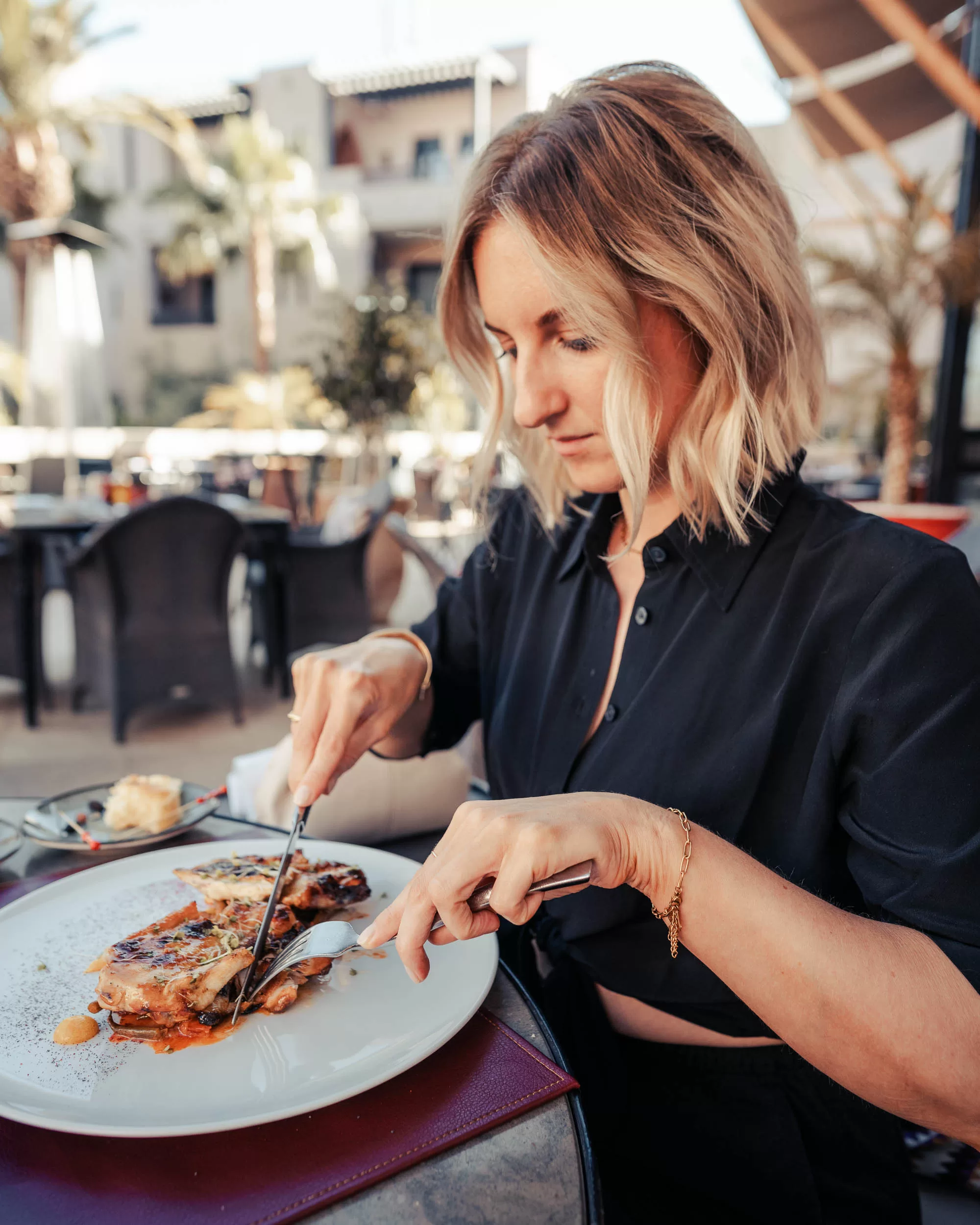 Woman eating a chicken dish