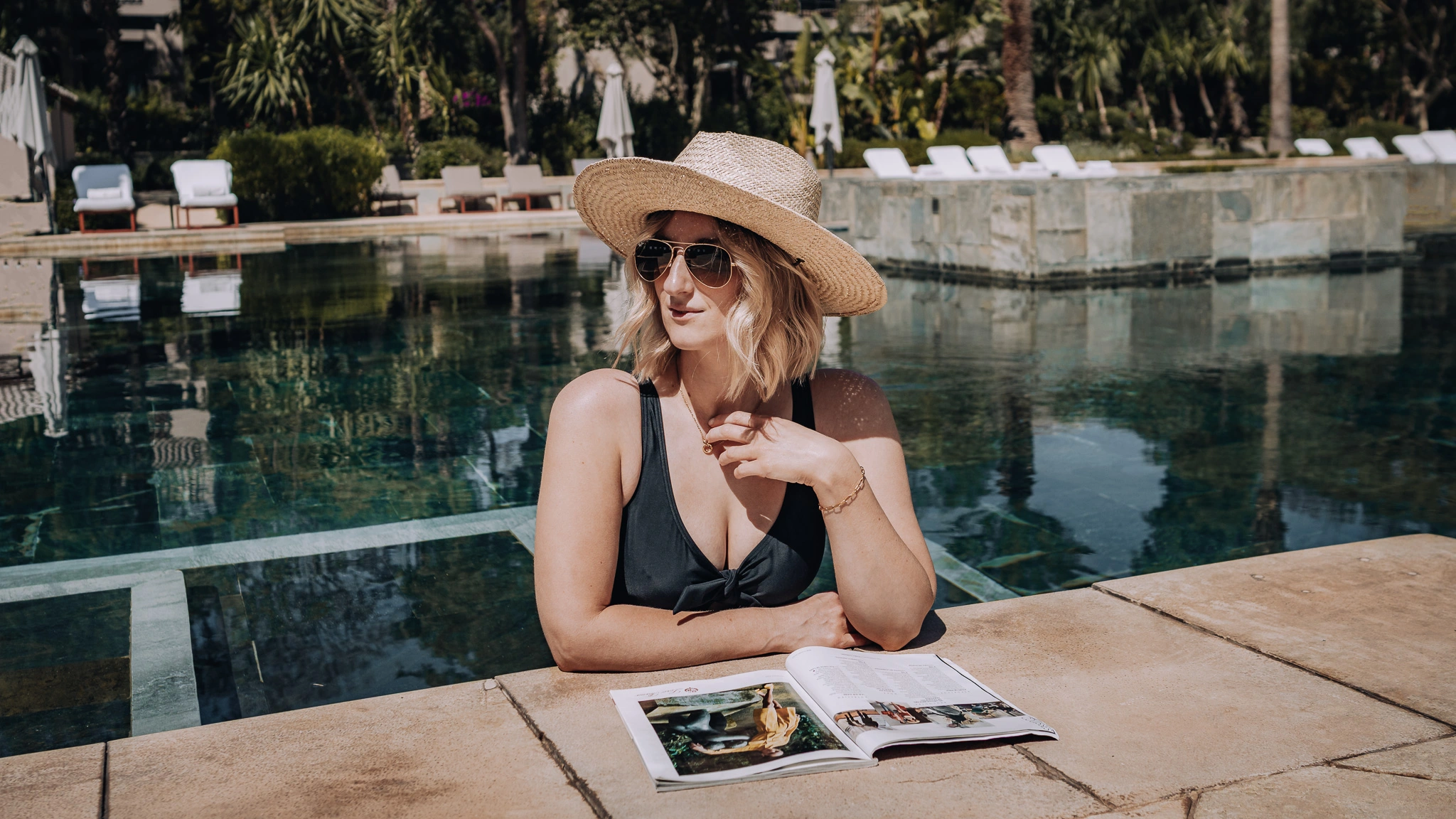Woman relaxing by the pool at Four Seasons Marrakech during a luxury hotel stay