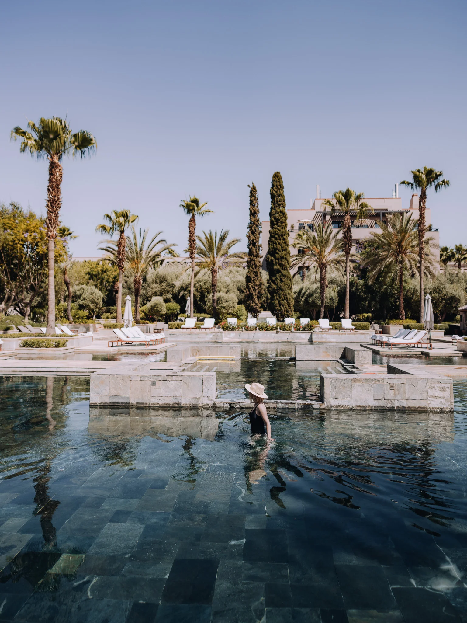 Guest walking through the pool area at Four Seasons Marrakech