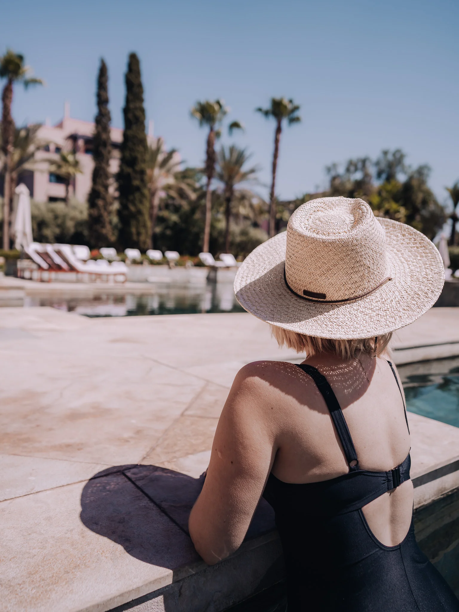 female relaxing beside the pool at Four Seasons Marrakech