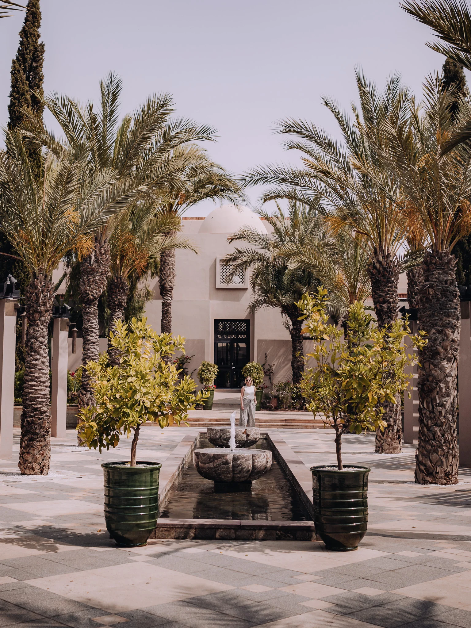 female standing beside the water feature at the Four Seasons Marrakech spa