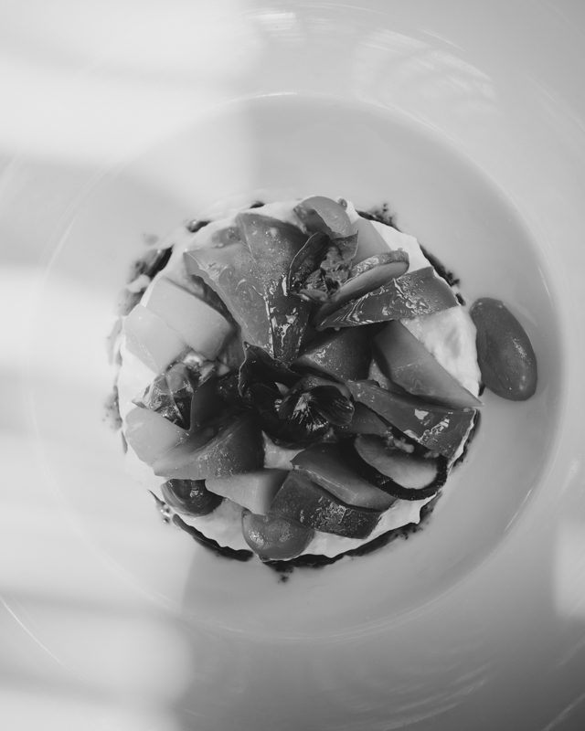 A pristine plate of food served on a white tablecloth.
