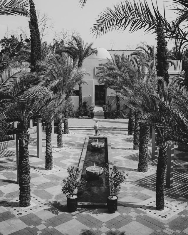 A traditional Moorish water feature with date palms lining the pool.