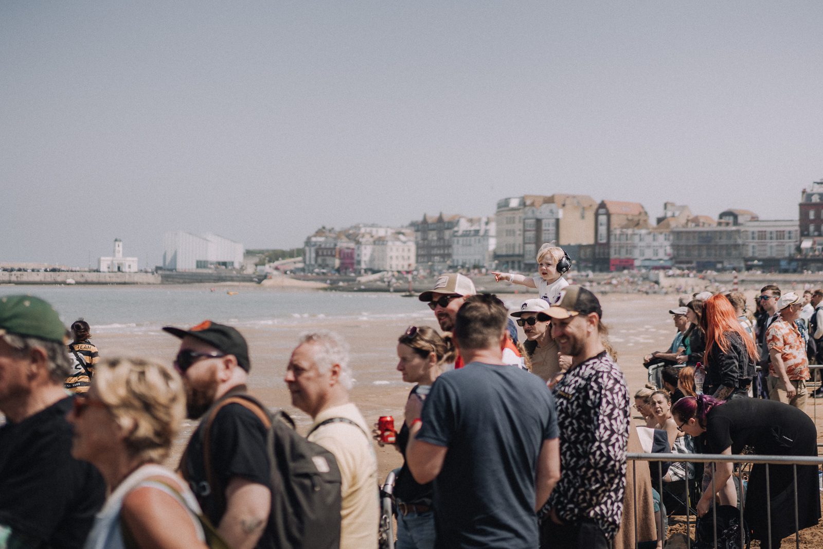 Crowd watching beach race event.