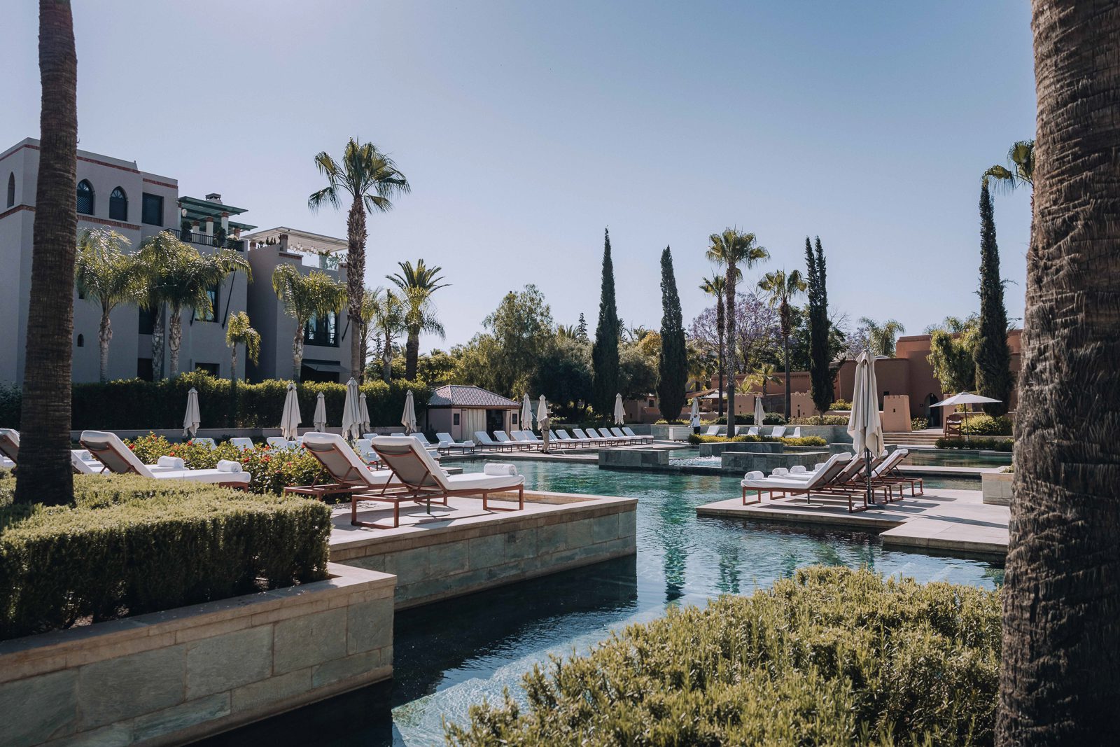Luxurious poolside with sun loungers.