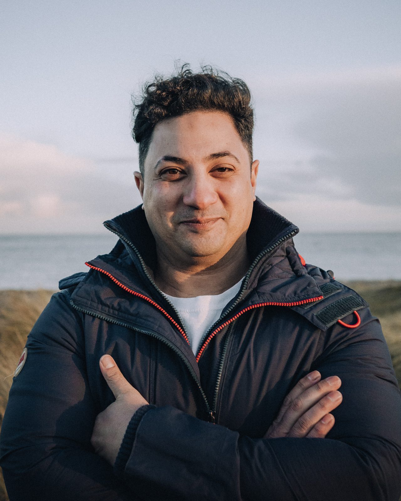 Man in a winter jacket smiling at the camera.