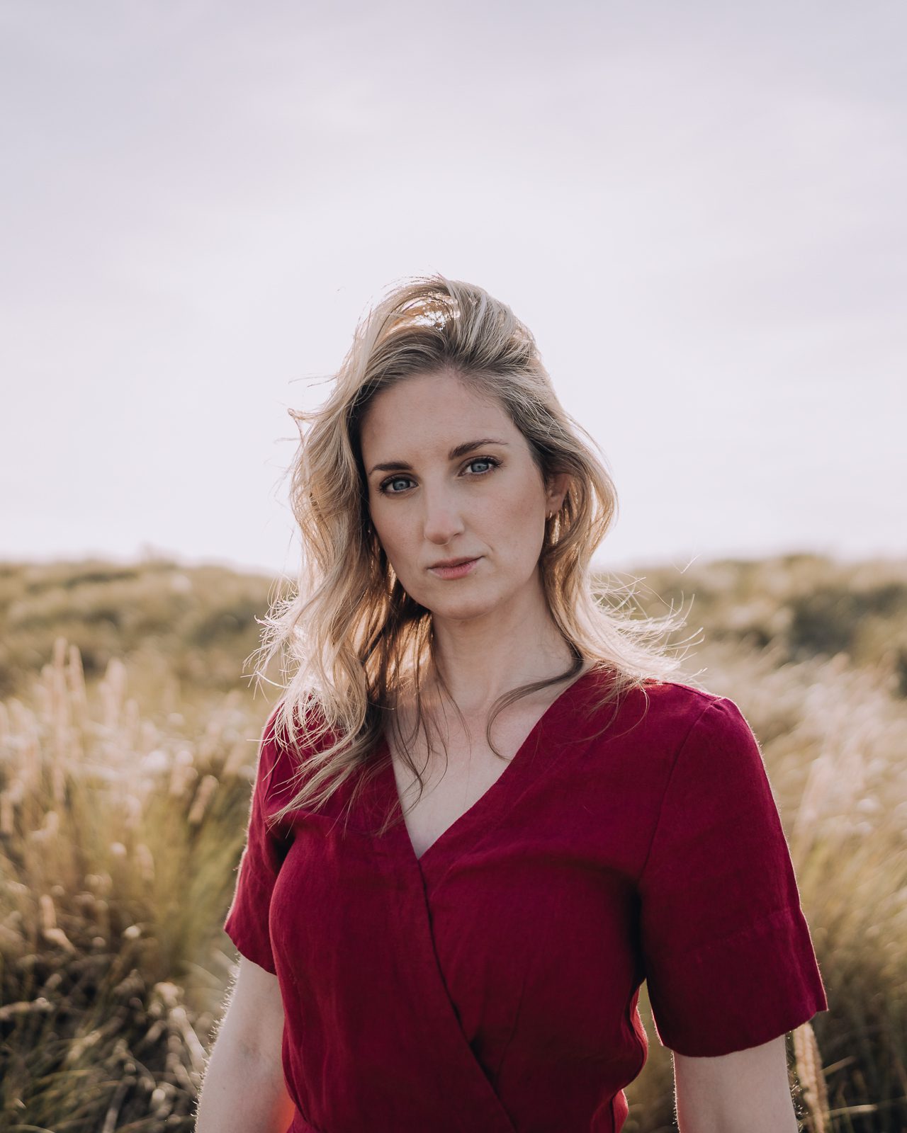 Woman in red dress outdoors.