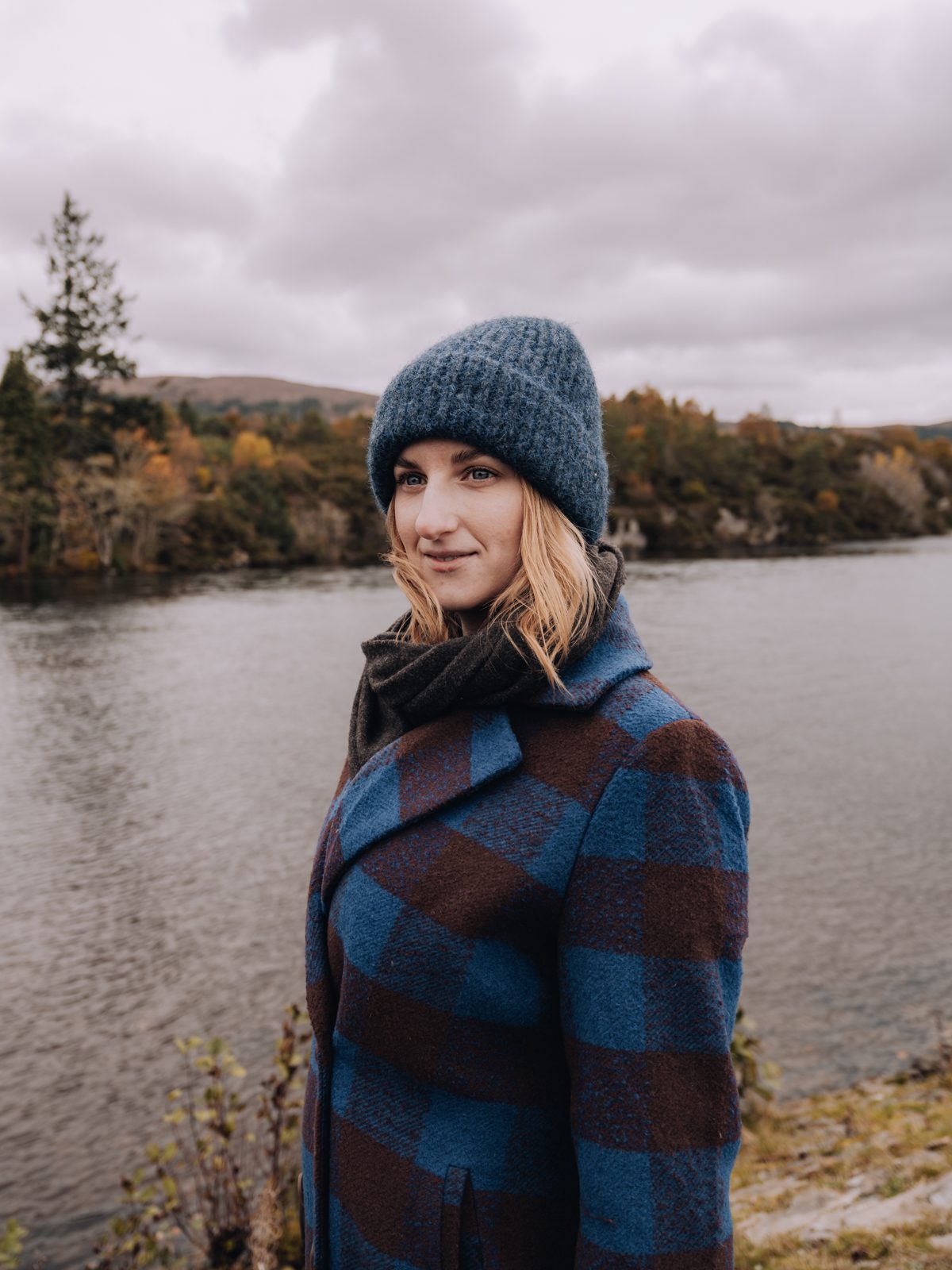 Woman by river in autumn attire