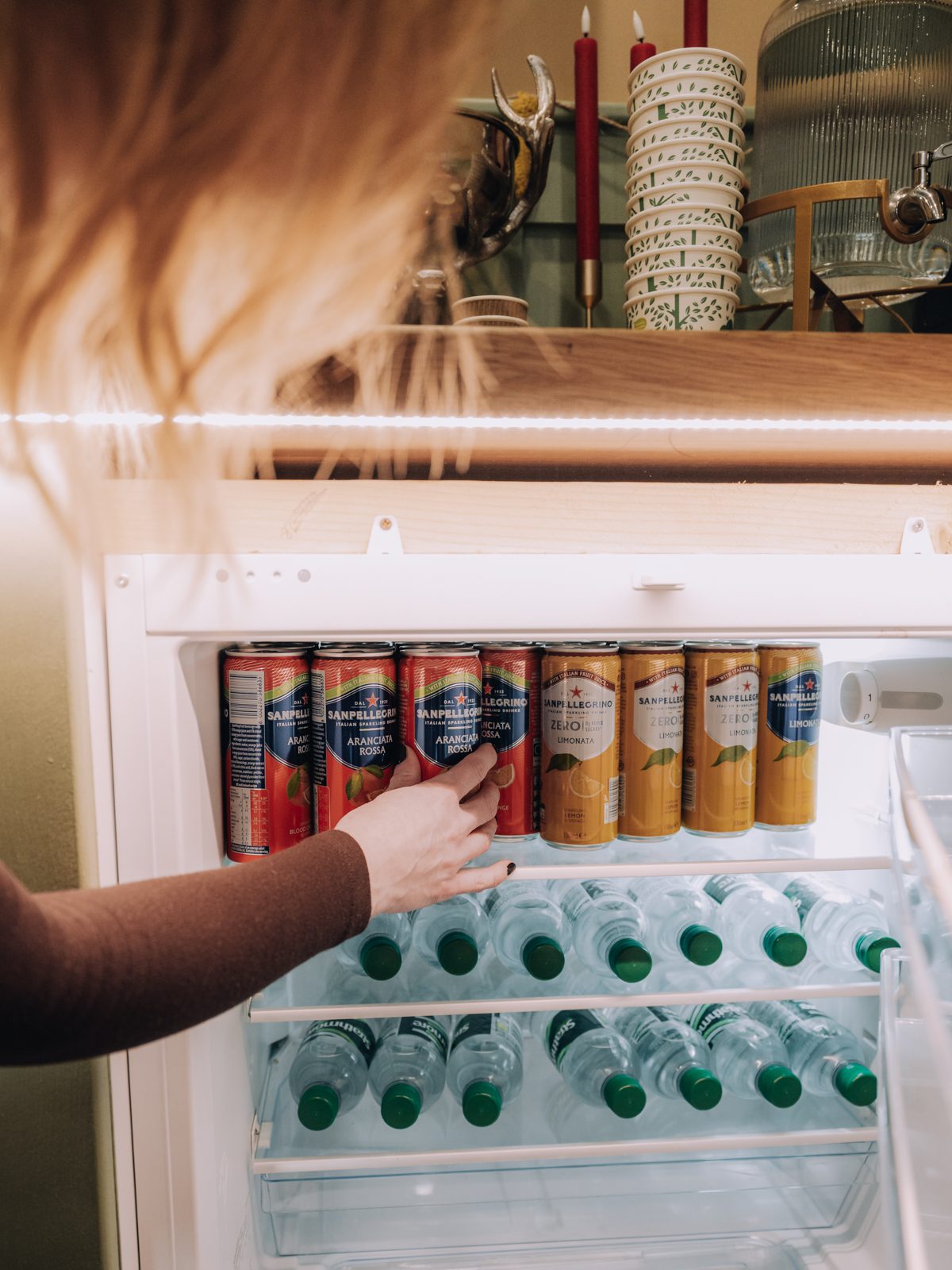 Person reaching for a drink can.
