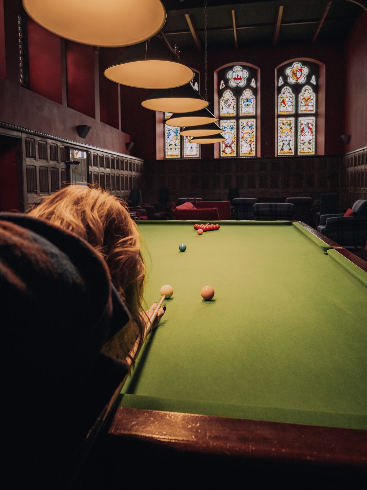 female playing pool in the games room
