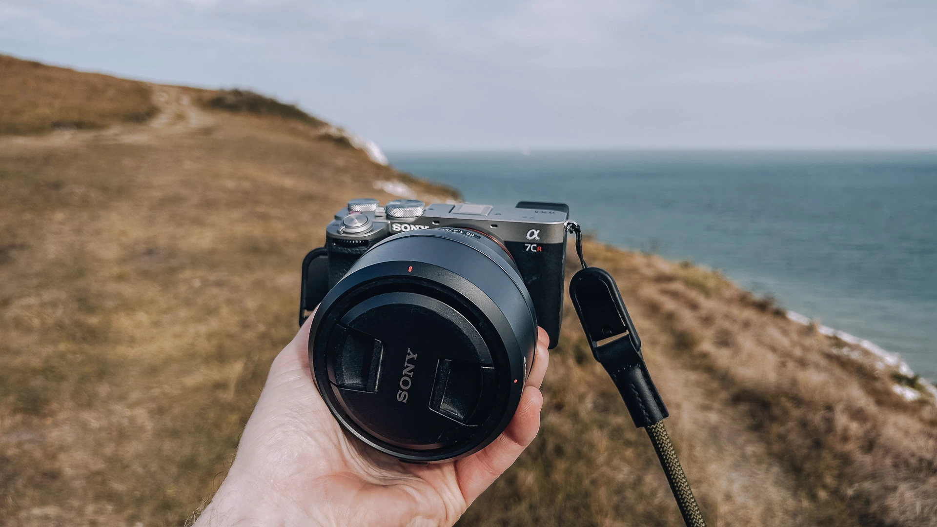 Sony A7CR mirrorless camera on a rugged coastal cliff, photographed for Pete Rudd's travel photography kit 2026 .