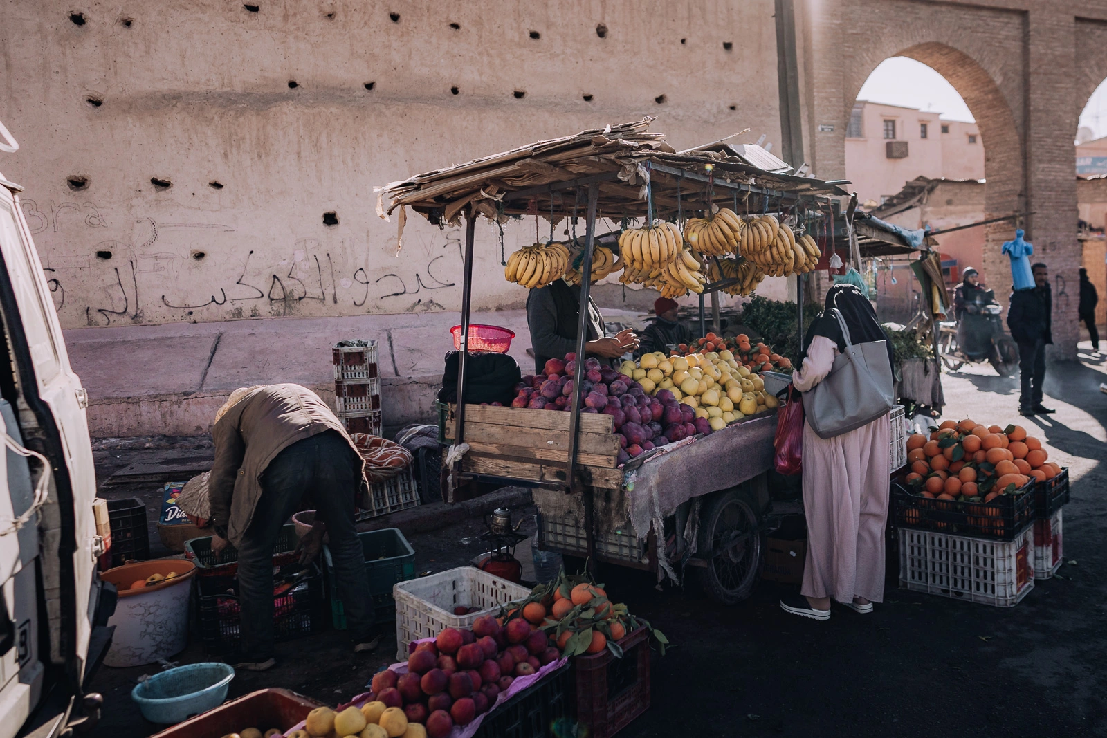 Woman buying fresh fruit and vegetables at a market in Marrakech, Morocco