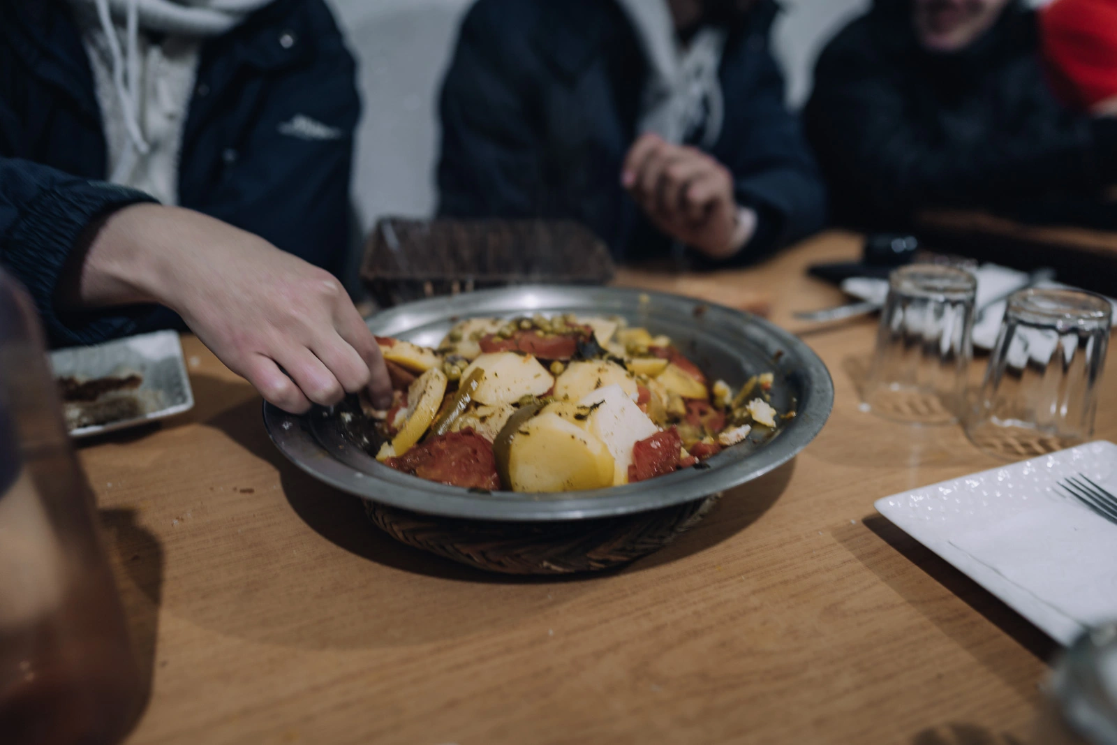Pete sharing dinner with new friends at a mountain refuge during the Mount Toubkal trek
