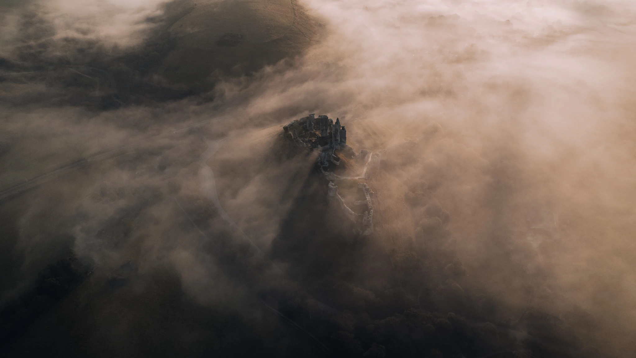 Sunrise drone photo over Corfe Castle in Dorset, England.