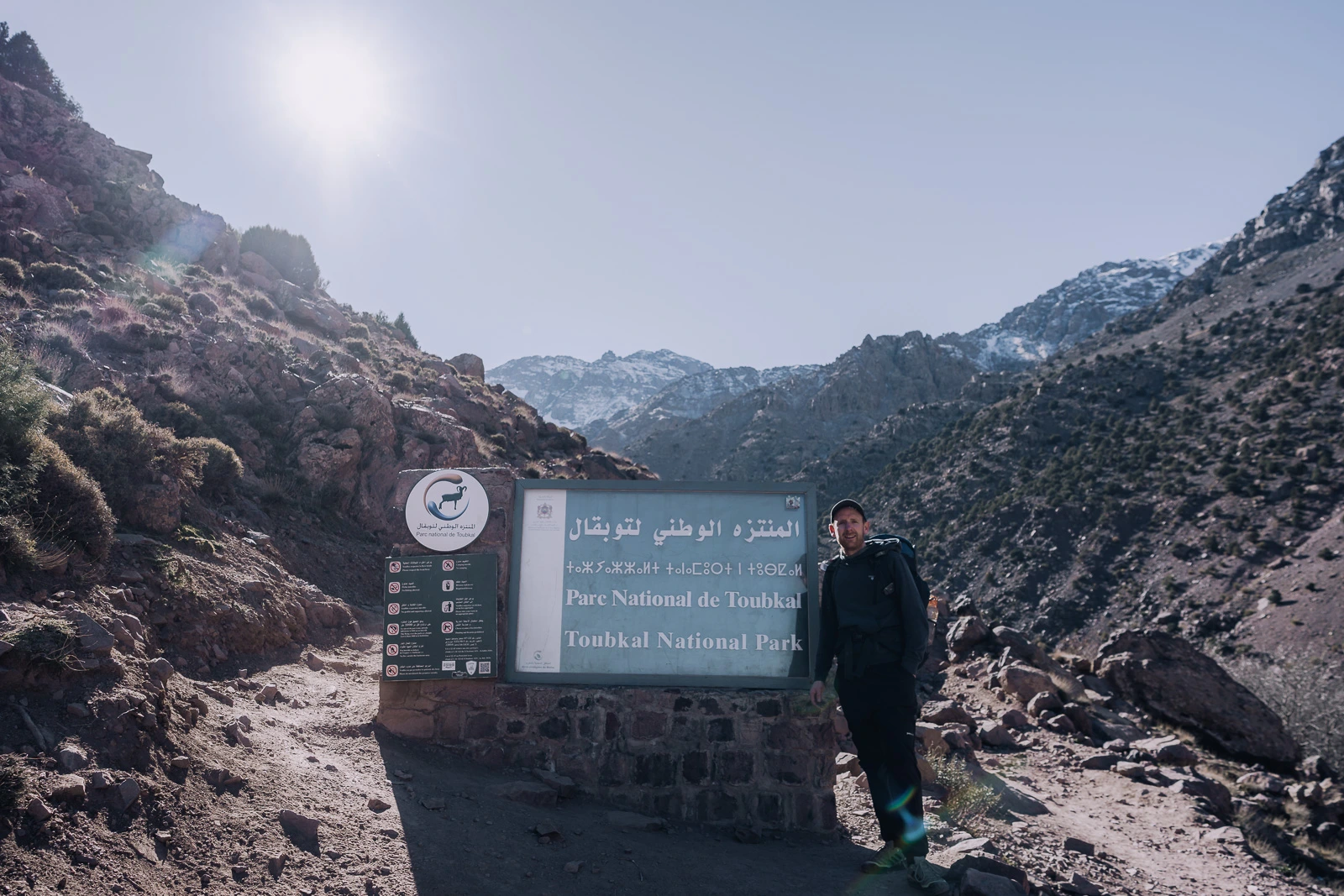 Pete standing beside the Mount Toubkal National Park sign in Morocco