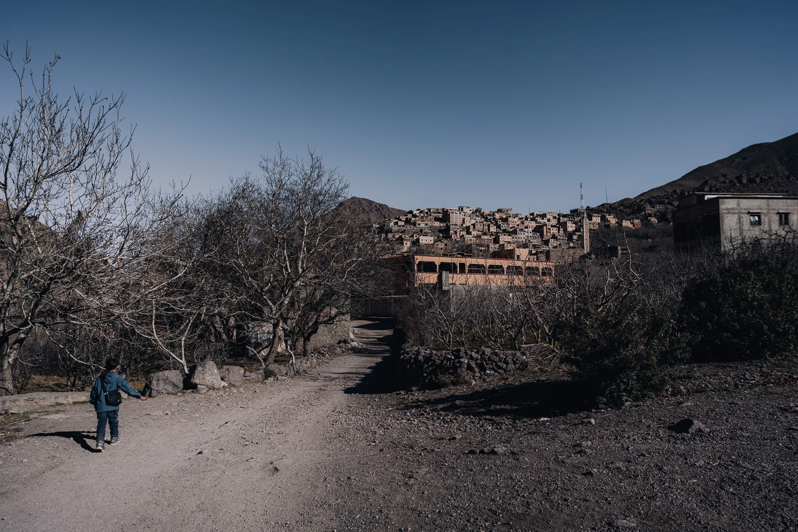 Child walking along a pathway to a Berber village in Morocco