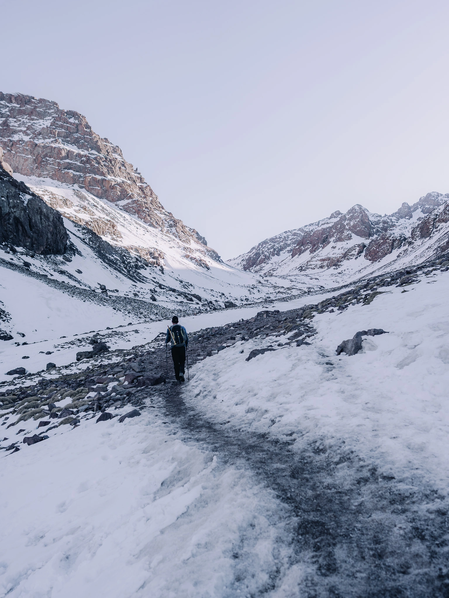 Guide walking through the snow on Mount Toubkal in Morocco