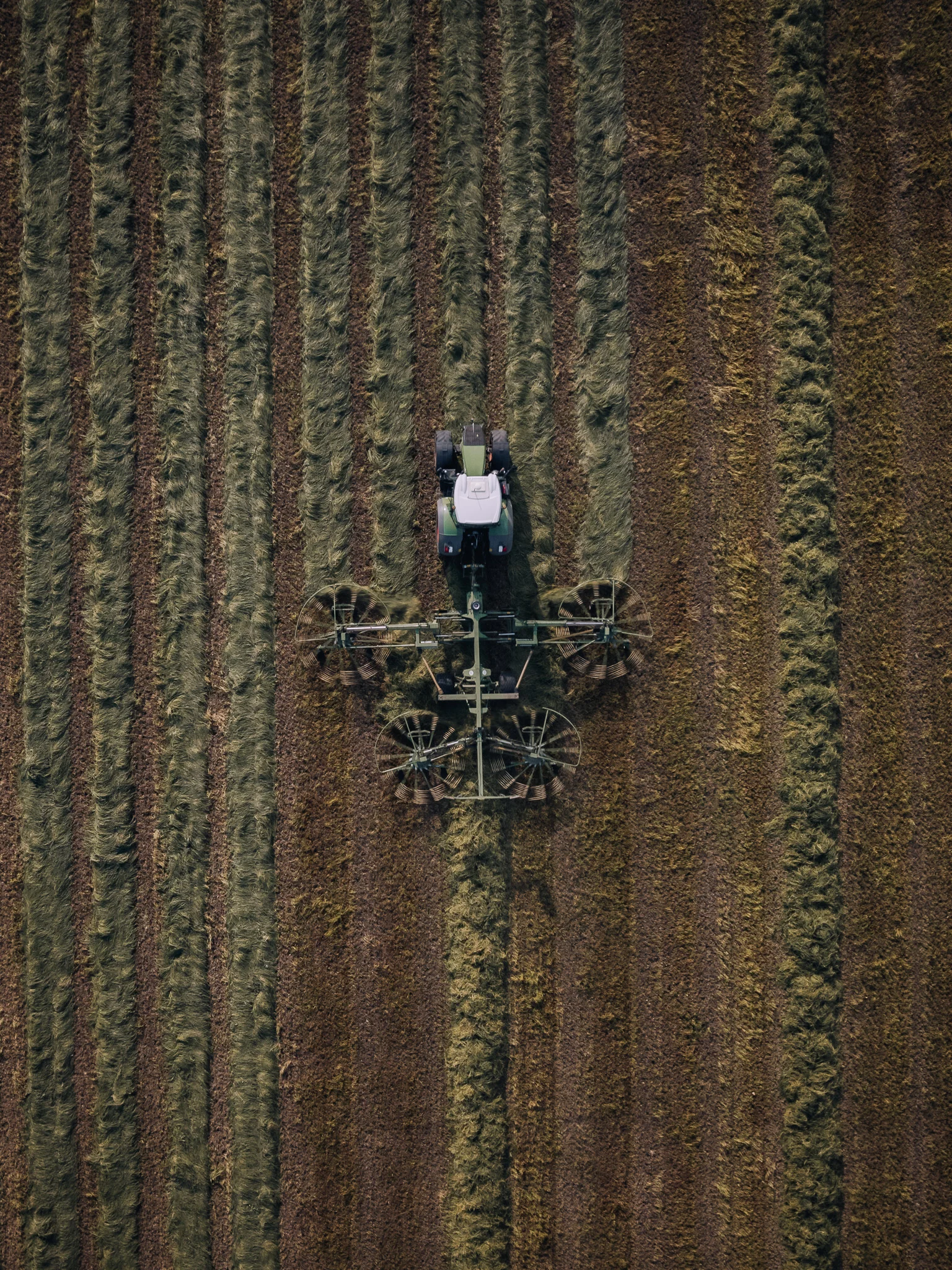 Combine harvester working in the fields at Bibury Farm Barns