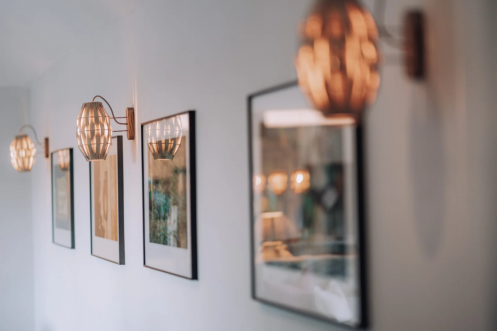 Wall artwork with gallery lighting inside the Bull Pen at Bibury Farm Barns
